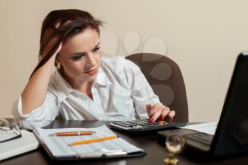 Tired young woman accountant at workplace concept. Female bookkeeper at the office
