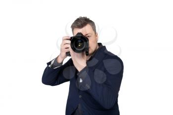 Photographer with digital camera taking picture, front view, white background