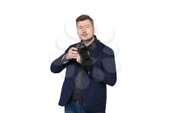 Portrait of professional cameraman with digital photo camera, front view, white background