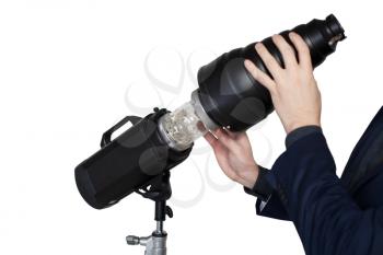 Professional photographer hands adjusts the lighting in photo studio, white background