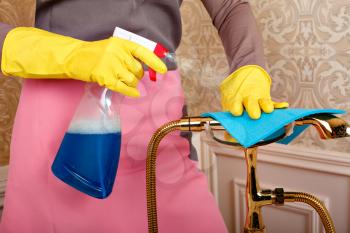 Female person hands in rubber gloves cleans bathroom. Housekeeping concept