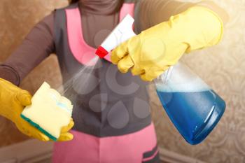 Female person hands in rubber gloves work with washing sponge and cleaning agent. Housekeeping concept