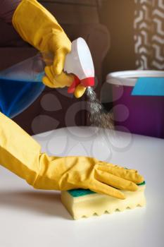 Female person hands in rubber gloves wash the table. Cleaning servisce concept