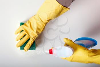 Female person hands in rubber gloves wash the table. Cleaning servisce concept