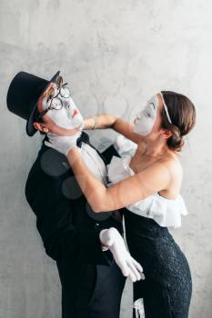 Two pantomime theater artists performing. Mime actors with white makeup masks on faces