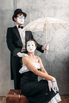 Pantomime theater performers posing with vintage umbrella. Mime actors comedy performing