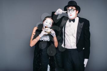 Mime actors performing, actress nibble alarm clock. Pantomime theater performers