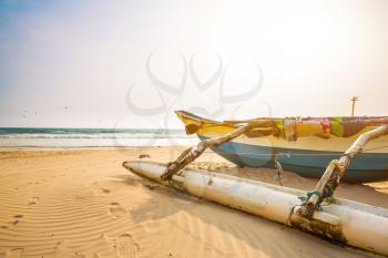 Fishing boat and sandy beach on Ceylon. Sri Lanka sands, indian ocean