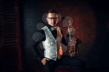 Male saxophonist posing with saxophone, jazz man. Jazz-man concept