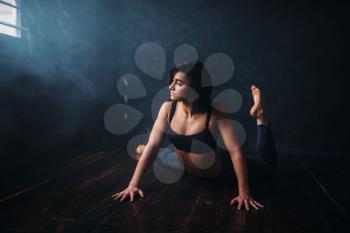 Contemp dancing female performer exercise in dance class. Woman pose in studio, acrobat body flexibility
