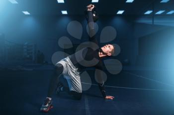 Athletic man on training, workout with barbell in gym. Active exercises in sport club