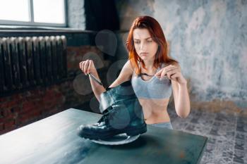 Fat or calories burning concept. Weight loss, anorexia illness. Unhappy skinny woman against plate with boot, absence of appetite. 