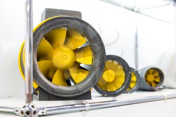 Air fans, exhibition sample in the store. Ventilation system engine on the shelf in the shop