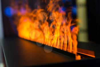 Flame line from gas fireplace, closeup. Fire, romantic interior decoration