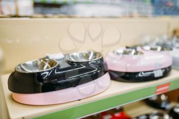Petshop, shelf with water bowls for dogs and cats, nobody. Zooshop variety, pet shop
