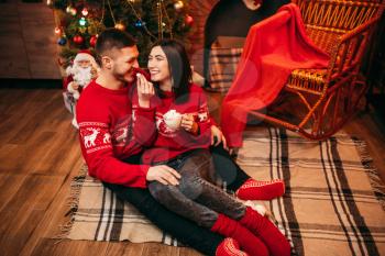 Love couple, romantic xmas celebration. Christmas holidays, man and woman having fun, festive decoration on background
