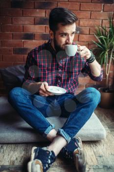 One male visitor sitting in coffee house in drinks beverage. Male person leisure in pub