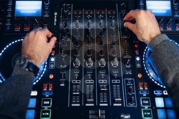 Sound operator hands over the remote control panel in the recording studio. Musician at the mixer, professional audio mixing