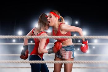 Two female boxers in motion, women fights on the ring. Fighting sport and martial art concept