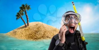 Female diver in wetsuit and diving gear, desert island on background. Frogman in mask and scuba, underwater sport