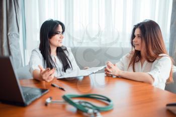 Family doctor examination, young wife talks with specialist. Female patient on cosultation, professional health care