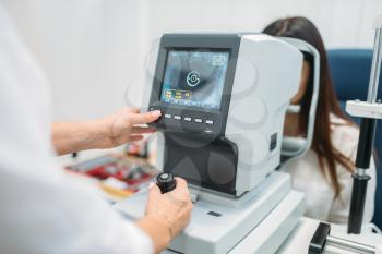 Computer diagnostics of vision, professional choice of glasses. Eyesight examination in optician cabinet