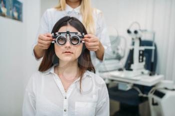 Eyesight test in optician cabinet, diagnostic of vision, professional choice of glasses. Patient and ophthalmologist, eye care consultation with specialist