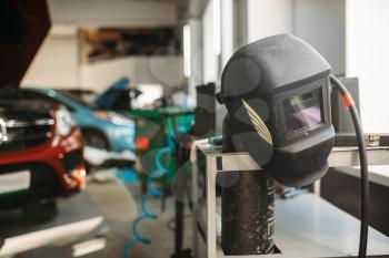 Welding helmet in car service , nobody. Professional auto-service tools and equipment, auto body works