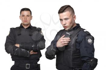 Cops in black uniform and body armor on white background. Two police officers in special ammunition