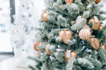 Christmas fir tree decorated with golden toys closeup view, nobody. Xmas holiday celebration symbol, bauble decoration