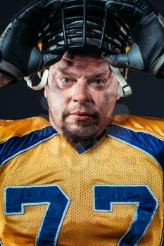 American football player face, helmet on the head, national league, black background