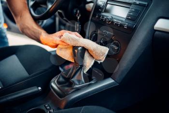 Male hands cleans car interior on carwash station. Automobile cleaning 