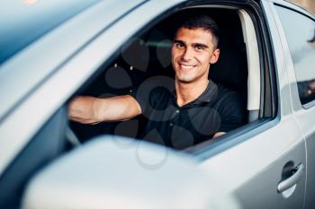 Happy male driver in car, advertising concept. Automobile driving