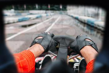 Karting driver on start line, view through the eyes of the racer. Go-kart speed track