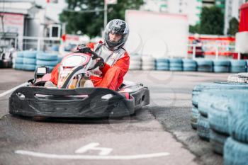 Karting racer in action, go kart competition on outdoor track. Carting championship