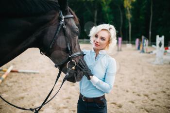 Woman hugs her horse, friendship, horseback riding. Equestrian sport, young woman and beautiful stallion, farm animal