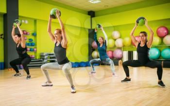 Women group with balls in motion, fitness workout. Female sport teamwork in gym. Fit exercise, aerobic