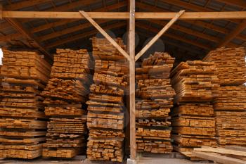 Boards on timber warehouse outdoor, nobody, lumber industry, carpentry. Wood processing on factory, forest sawing in lumberyard, sawmill