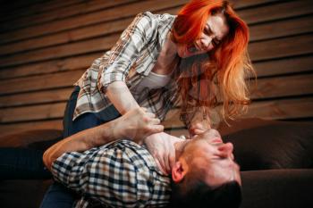 Wife try to strangles her husband, quarrel, family conflict, domestic violence. Problem relationship