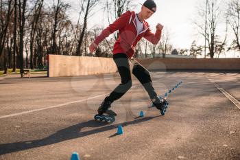 Roller skater, rollerskating trick exercise in park. Male rollerskater leisure