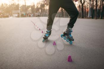 Rollerskater, rollerskating trick exercise in park. Male roller skater leisure on sidewalk