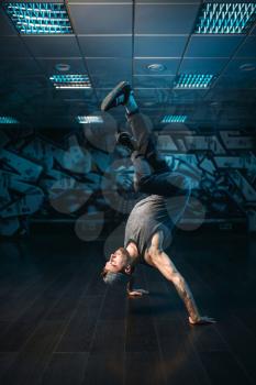 Hip hop motions, male performer in dance studio. Modern urban dancing style