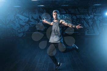 Male rapper in dance studio, trendy lifestyle. Modern urban dancing style