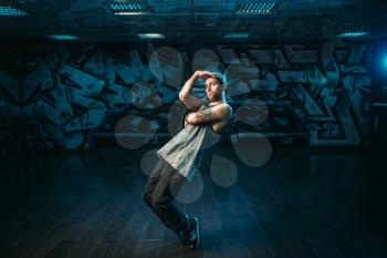 Male rapper in dance studio, rap performer. Modern urban dancing style