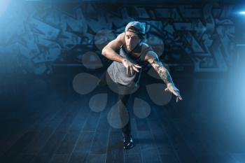Breakdance motions, performer in dance studio. Modern urban dancing style