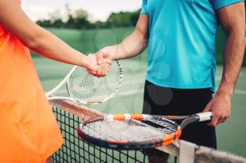 Male and female players on outdoor tennis court. Summer season active sport game