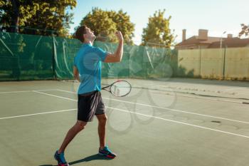 Man with tennis racket on outdoor court. Summer season active sport game. Happy leisure