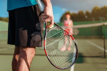 Male and female person playing tennis outdoor. Summer season active sport game