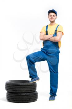 Tire serviceman isolated on white background, repairman with tyres