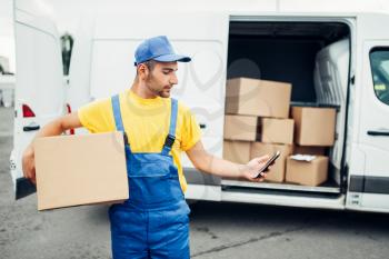 Cargo delivery service, male courier in uniform with box and mobile phone in hands. Empty container